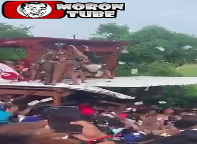 Video :As she distributes money to the audience, she tumbles from a roof
